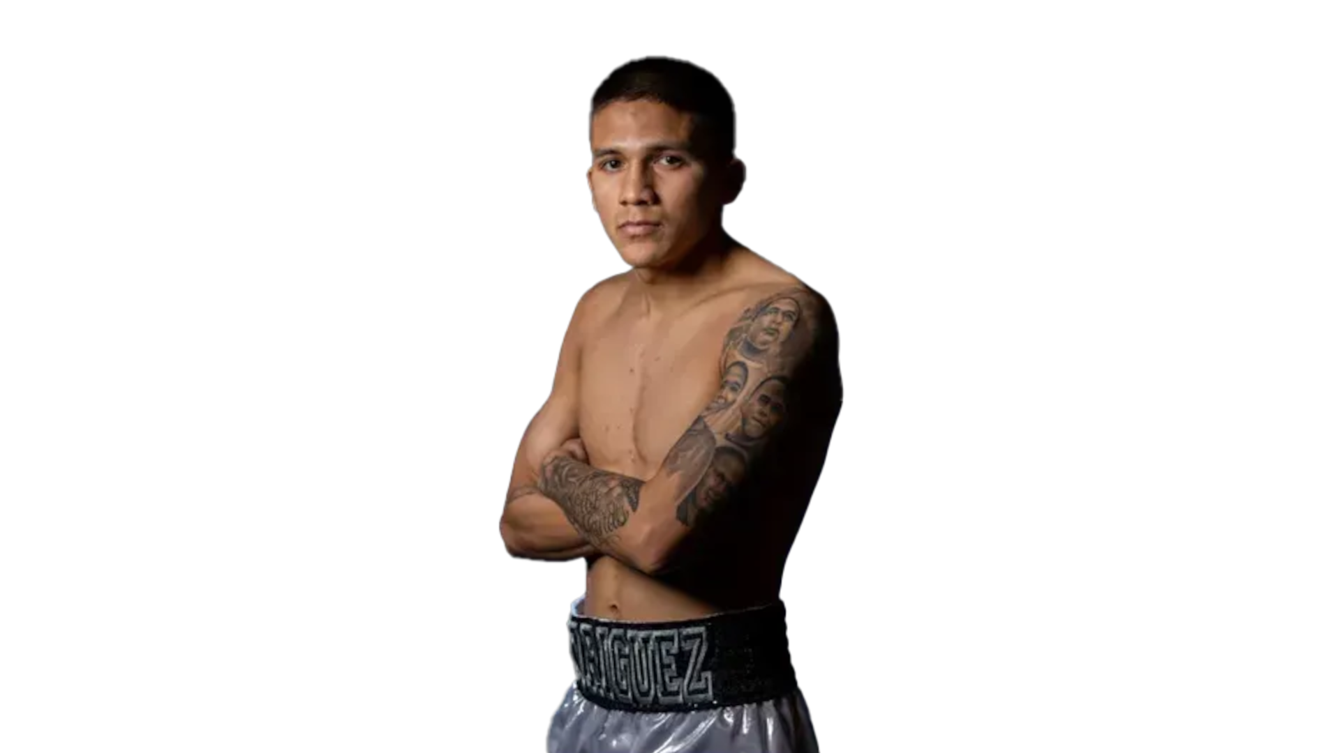 Jesse Bam Rodriguez with arms crossed, showing detailed sleeve tattoos.