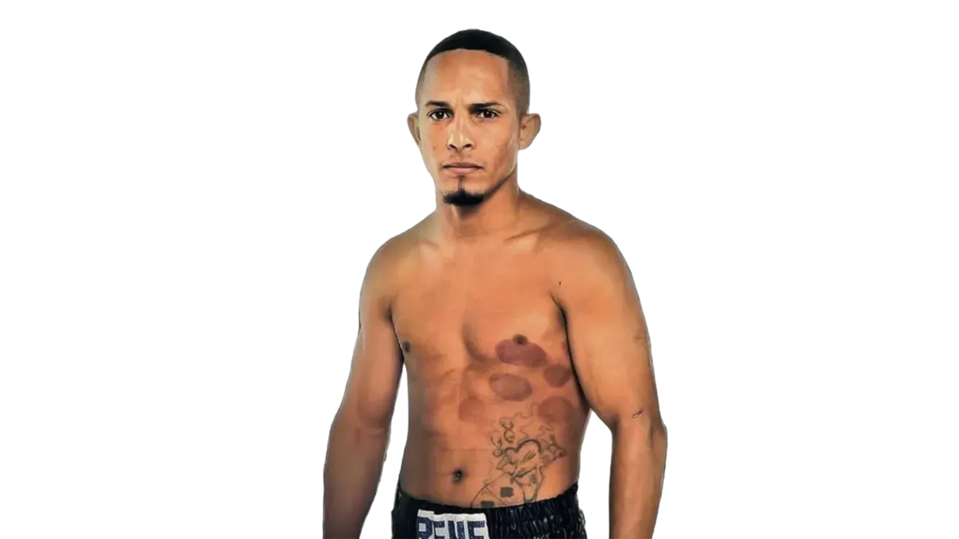 Rene Santiago standing shirtless, showing chest tattoos and a stern expression.