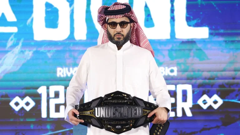Turki Alalshikh holding the Undisputed Championship belt during a Riyadh Season boxing event announcement.