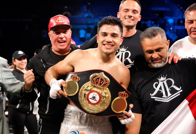 Armando Resendiz holds the WBA title belt and smiles with his team after his split-decision victory over Caleb Plant in Las Vegas, 31 May 2025