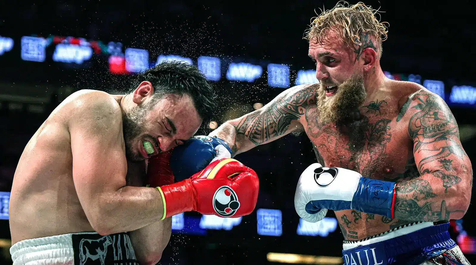Jake Paul lands a powerful right hand on Julio César Chávez Jr. during a boxing match.