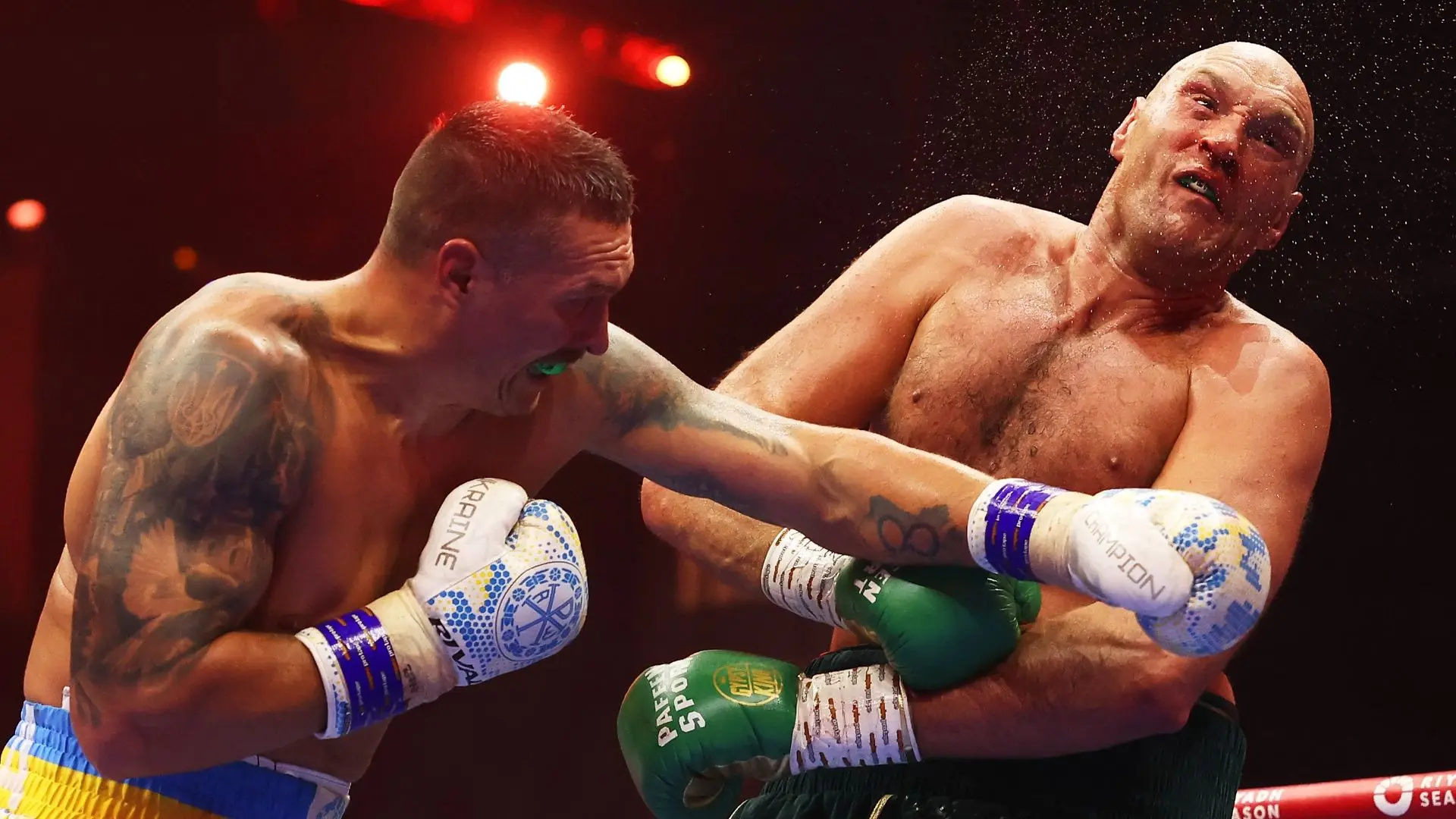 Oleksandr Usyk lands a clean left on Tyson Fury during their championship bout.